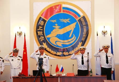 Naval officers from China and Russia salute at the opening of the joint naval drills in Vladivostok, Russia, July 8, 2013. China and Russia started on Monday the joint naval drills off the coast of Russia's Far East. (Xinhua/Zha Chunming)  