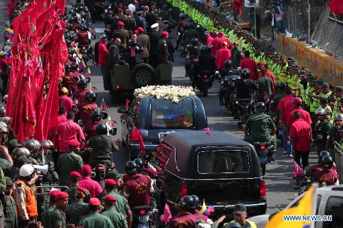 The body of late Venezuelan President Hugo Chavez is carried from the Military Academy to the Mountain Barracks, in the city of Caracas, capital of Venezuela, on March 15, 2013. Venezuelans honored late President Hugo Chavez, before his remains were transfered to the Mountain Barracks, where he will rest inside a glass case. Venezuelan President died on March 5, after struggling with cancer for two years. (Xinhua/AVN) 