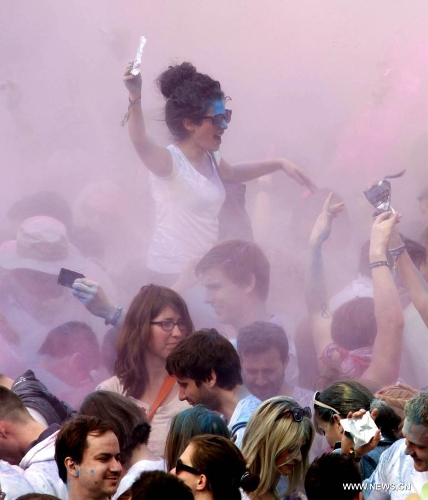 People throw colorful powder during the Holi Festival of Colours, at the Reiterstadion in Berlin, Germany, May 11, 2013. The celebration of Holi Festival of Colours has been launched in Germany since 2012 as a new carnival of German people marking the advent of spring. (Xinhua/Pan Xu) 