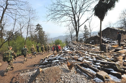Rescuers leave a landslide spot in Zhenxiong mountain of Zhaotong City, southwest China's Yunnan Province, Jan. 12, 2012. The rescue of a landslide which hit the Zhaojiagou area of Gaopo Village early Friday finished after all 46 bodies were retrieved Saturday. (Xinhua/Chen Haining)