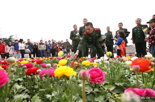 Soldiers present flowers at a monument during a memorial ceremony held at Yuhuatai Martyr Cemetery in Nanjing, capital of east China's Jiangsu Province, March 30, 2013. Various memorial ceremonies were held across the country to pay respect to martyrs ahead of the Qingming Festival, or Tomb Sweeping Day, which falls on April 4 this year. (Xinhua) 