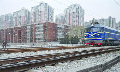 A train passes by residential buildings along the Beijing-Baotou railway in Beijing. The new high-speed railway to Shenyang is planned to go parallel with this route. Photo: Liu Sha/GT