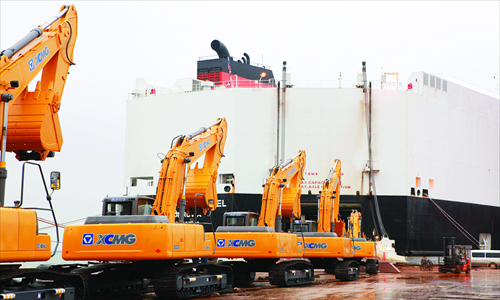 Excavators produced by Xuzhou-based heavy machine maker XCMG Group line up in July 2012, waiting to be exported to Venezuela. Photo: CFP