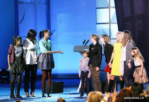The First Lady Michelle Obama with her two daughters (L) greet Vice President Joe Biden's families (R) during the 