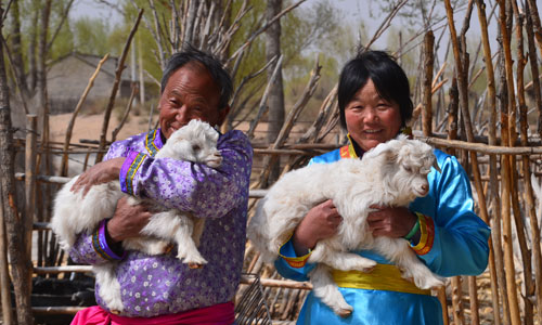 Herdsmen and their lamb Photo: Sand River