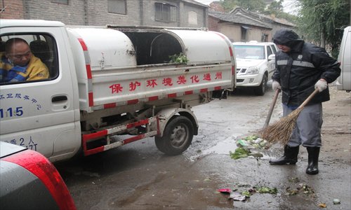 Zhang Yuan (right) collects garbage from the street. Since September 10, trash has been collected door-to-door from residents of Zhongcang Nandajie, Tongzhou district. Photo: Zhang Yiqian/GT