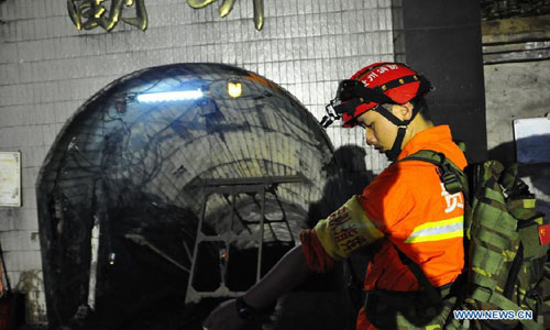 A rescuer prepares to carry out rescue operation at the Guba Coal Mine in Longchang Township of Fuquan City, southwest China's Guizhou Province, September 12, 2012. A coal mine flooding happened here at about 11:30 pm Tuesday, when 41 miners were working underground. Eight miners were trapped in the coal mine. The rescue operation is under way. Photo: Xinhua