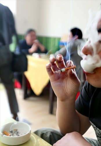 A man smokes in a restaurant in Taiyuan, Shanxi Province in May, 2011. Photo: CFP