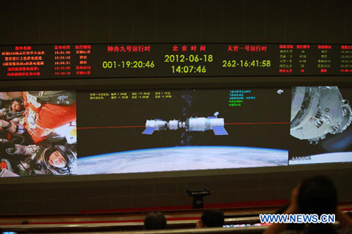 Photo taken on June 18, 2012 shows the screen at the Beijing Aerospace Control Center showing Shenzhou-9 manned spacecraft conducting an automatic docking with the orbiting Tiangong-1 space lab module. Photo: Xinhua
