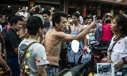 A restaurant owner gestures at animal rights activist Du Yufeng during a verbal fight in Yulin, South China's Guangxi Zhuang Autonomous Region on June 21, locally known as 