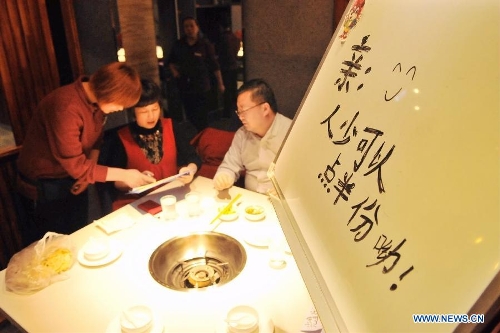  Customers order at a hot pot restaurant in Lanzhou, capital of northwest China's Gansu Province, Jan. 30, 2013. A 