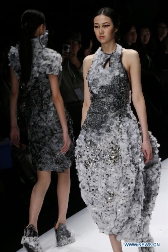 Models present creations designed by students from China Academy of Art during the 1st China Graduate Fashion Week in Beijing, capital of China, April 24, 2013. A total of 610 graduate students from 22 universities will present their designs during the five-day event which kicked off on Wednesday. (Xinhua/Li Mingfang)