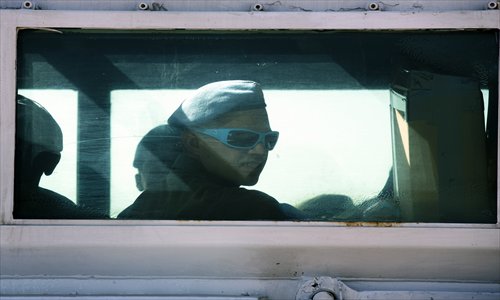 UN Austrian peacekeepers ride in a vehicle across the Israeli army crossing of Quneitra between Syria to the Israeli-annexed Golan Heights on Wednesday.  Austrian troops in the UN monitoring force on the Golan Heights began withdrawing, days after Vienna decided to quit the mission over security concerns, an AFP photographer said. Photo: AFP