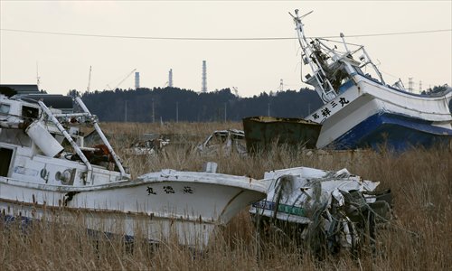 Fukushima Daiichi Nuclear Power Plant is seen on March 6 over fishing boats stranded by the 2011 tsunami triggered by a 9-magnitude earthquake in Namie, Fukushima Prefecture. Photo: CFP
