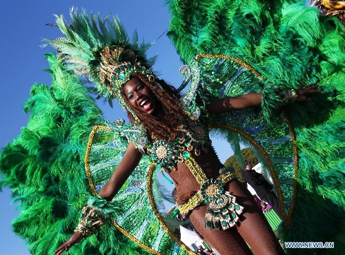 A performer takes part in the flowers parade during the 129th annual Nice Carnival parade, in Nice, southern France, March 2, 2013. (Xinhua/Gao Jing) 
