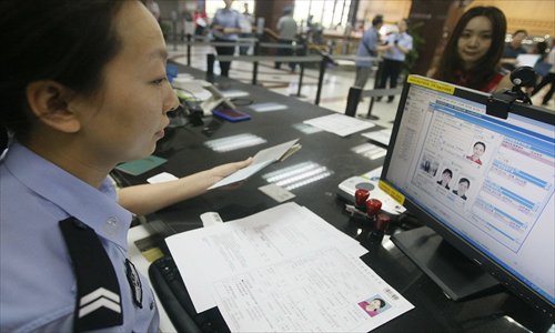 The Beijing Exit-Entry Administration Department serves a resident who is applying for a passport. Photo: CFP