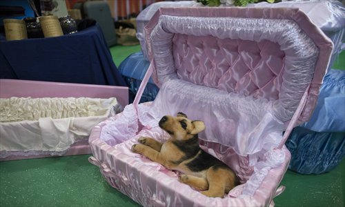 A toy dog rests in a coffin specially designed for pets at the Asia Funeral and Cemetery Expo and Conference in Hong Kong on Saturday. Photo: CFP