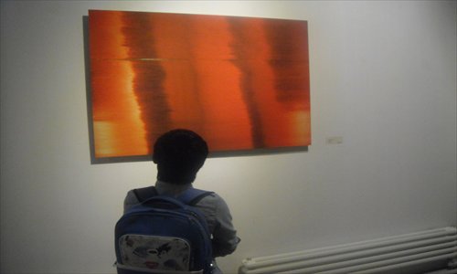 A visitor admires Bei Dao's photograph Hue. Photo: Zhang Zihan/GT 