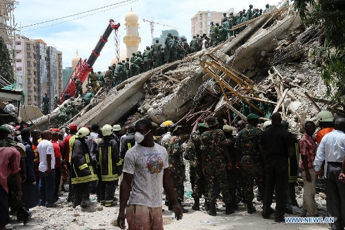 Rescuers search for survivors at the building collapse site in downtown Dar es Salaam, Tanzania, March 29, 2013. A 16-storey building on Friday morning collapsed in Dar es Salaam, with more than 60 people got trapped in the debris. No casualties have been reported as of noon local time. (Xinhua/Zhang Ping)