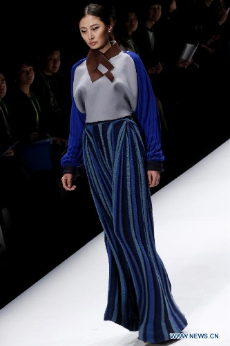 A model presents a creation designed by students from China Academy of Art during the 1st China Graduate Fashion Week in Beijing, capital of China, April 24, 2013. A total of 610 graduate students from 22 universities will present their designs during the five-day event which kicked off on Wednesday. (Xinhua/Li Mingfang)