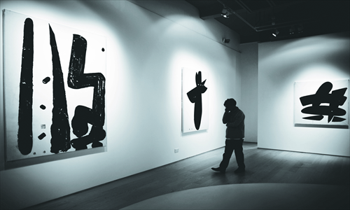  Johnson Chang, curatorial director of the Hanart TZ Gallery that will be exhibiting at Art Basel Asia, talks on his mobile phone in Hong Kong on May 16, 2013. Photo: IC