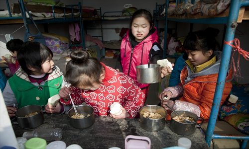 Girls have lunch in their dormitory. Photo: CFP