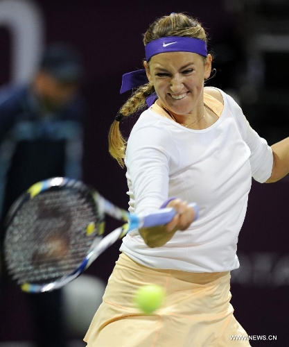 Victoria Azarenka of Belarus returns a shot to Agnieszka Radwanska of Poland during their women's semifinal at the Qatar Open tennis tournament in Doha, capital of Qatar, Feb. 16, 2013. Azarenka won 2-0. (Xinhua/Chen Shaojin) 