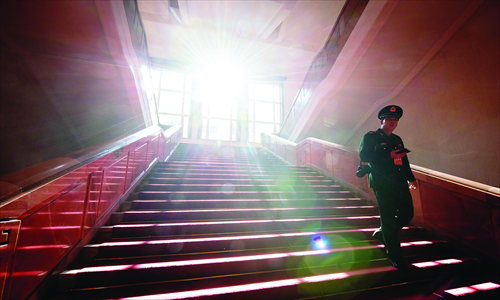A military delegate walks down stairs at the Great Hall of the People during the closing ceremony of the 18th Party congress in Beijing on Wednesday. Photo: AFP