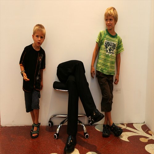 Two boys pose by an exhibition on the closing day of SH Contemporary 2012 at Shanghai Exhibition Center.
Photo: Cai Xianmin/GT