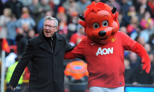 Manchester United manager Alex Ferguson (left) greets mascot Fred the Red before the English Premier League soccer match against Queens Park Rangers on April 8, 2012 at Old Trafford in Manchester, England. Photo: AFP