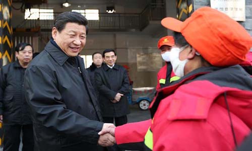Xi Jinping (L), general secretary of the Communist Party of China (CPC) Central Committee and chairman of the CPC Central Military Commission, shakes hands with a sanitation worker in the Shoupakou cleaning station of the sanitation center of the Xicheng District in Beijing, capital of China, February 8, 2013. Xi Jinping on Friday visited and extended greetings to laborers including subway construction workers, sanitation workers, police officers and taxi drivers in Beijing, ahead of the Chinese traditional Spring Festival, which starts on Feb. 10 this year. Photo: Xinhua

