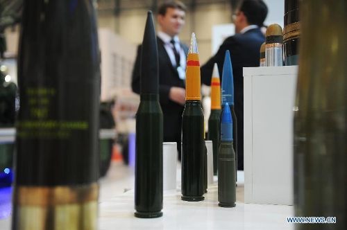Guests talk with each other in front of an ammunition booth in Istanbul, Turkey, May 7, 2013. The 11th International Defence Industry Fair was opened on Tuesday, with 781 companies from 82 countries and regions attending the four-day fair. (Xinhua/Lu Zhe) 