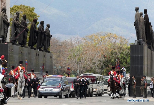 The body of late Venezuelan President Hugo Chavez is carried from the Military Academy to the Mountain Barracks, in the city of Caracas, capital of Venezuela, on March 15, 2013. Venezuelans honored late President Hugo Chavez, before his remains were transfered to the Mountain Barracks, where he will rest inside a glass case. Venezuelan President died on March 5, after struggling with cancer for two years. (Xinhua/AVN) 