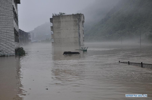 A building is flooded in rainstorm-hit Beichuan Qiang Autonomous County, southwest China's Sichuan Province, July 9, 2013. Downpours have submerged the quake-razed old town ruins of Beichuan, which was hit by an 8.0-magnitude earthquake in May 2008. (Xinhua)