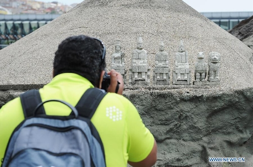 A visitor takes photos in front of the miniature of Mount Nemrut Ruins in the Miniature park in Istanbul, Turkey, on May 11, 2013. The Miniaturk park is the first miniature park in Istanbul and has welcomed 6.5 million visitors over the past 10 years. (Xinhua/Lu Zhe) 