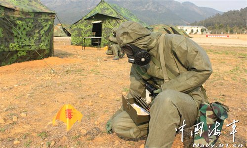 A shore-based mobile anti-ship-missile regiment under the South China Sea Fleet of the Navy of the Chinese People’s Liberation Army (PLA) organized a NBC (nuclear, biological and chemical) defense drill against actual-combat background on April 7, 2013. The picture shows the officers and men of the regiment are carrying out decontamination and detection of chemical agents in the infected “toxic” areas. (China Military Online/Sheng Yuehua, Zhao Changhong and Zheng Can)