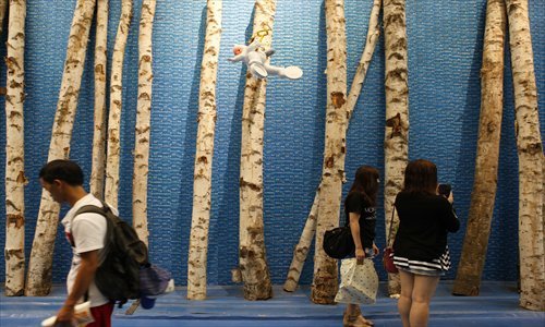 Visitors browse artworks at Wang Mai's 