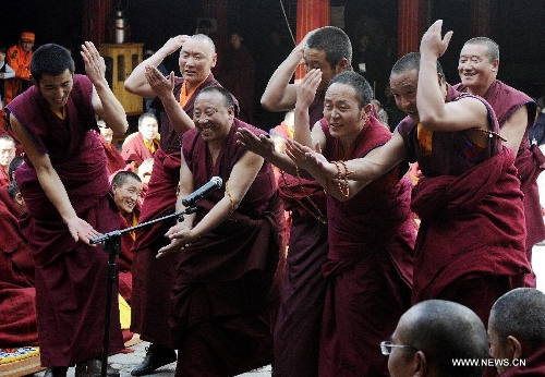 Monks ask questions at the ceremony of defending dissertations for Gexe Lharampa, the highest academic degree in Tibetan Buddhism studies, at the Jokhang Temple in Lhasa, capital of southwest China's Tibet Autonomous Region, April 5, 2013. Eight laureates of Gexe Lharampa were awarded here on Friday after they passed tests and defended their dissertations. Gexe means knowledgeable and Lharampa is the highest among the four ranks in the Gexe system. (Xinhua/Chogo)&nbsp; 