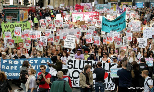 Women hold banners and shout slogans as they take part in a 