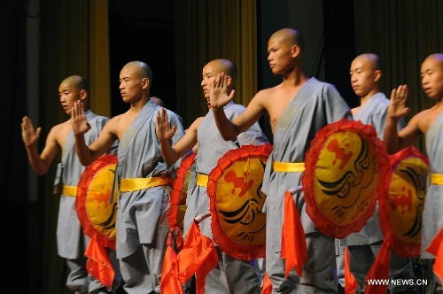 Performers of the Yandong Shaolin Kungfu troupe show their Kungfu during a performance held at the Worker's Cultural Palace, Taiyuan, capital of north China's Shanxi Province, July 6, 2013. The martial art troupe have their performers trained in the renowned Shaolin Temple, and staged performances worldwide in the hope of promoting Shaolin-style martial arts and Chinese culture. (Xinhua/Fan Minda)&nbsp; 