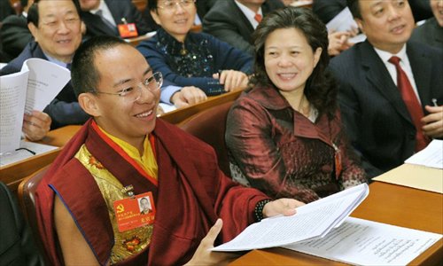 The 11th Panchen Lama, Bainqen Erdini Qoigyijabu (L), attends, as a nonvoting delegate, the opening ceremony of the 18th National Congress of the Communist Party of China (CPC) at the Great Hall of the People in Beijing, capital of China, on November 8, 2012. The 18th CPC National Congress opened in Beijing on Thursday. Photo: Xinhua