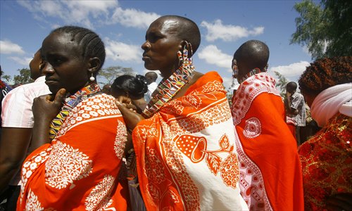 Masaai women wait outside a polling station to cast their vote at a primary school in Kajiado, a town located 80 kilometers south of Nairobi, Kenya, on March 4. Photo: AFP