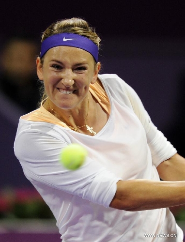 Victoria Azarenka of Belarus returns a shot to Agnieszka Radwanska of Poland during their women's semifinal at the Qatar Open tennis tournament in Doha, capital of Qatar, Feb. 16, 2013. Azarenka won 2-0. (Xinhua/Chen Shaojin) 