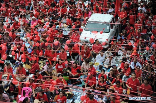 Thousands of supporters of the United Front for Democracy against the Dictatorship (UDD), or the Red shirts, rally to commemorate the third anniversary of the military crackdown on the anti-government protesters in the main shopping district of Bangkok, capital of Thailand, May 19, 2013. (Xinhua/Gao Jianjun)Related:Thai fugitive ex-PM Thaksin pushes for charter rewrite amid Red-shirts mass rallyBANGKOK, May 20 (Xinhua)-- Thailand's fugitive former Prime Minister Thaksin Shinawatra made a high-profile speech to his red- clad supporters Sunday night and called for continued effort to amend the constitution, which he said would bring 