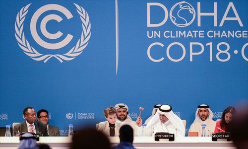 H.E. Abdullah Bin Hamad Al Attiyah (2nd R, front), President of the conference announces the final agreements of the UN Climate Change Conference (COP 18 and CMP 8) at the Qatar National Convention Center (QNCC) in Doha, Qatar, December 8, 2012. Photo: Xinhua