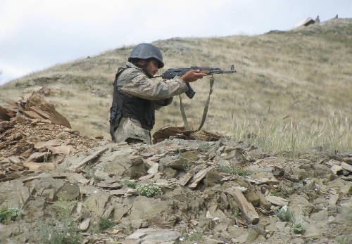 An Afghan policeman keeps watch on the border between Afghanistan and Pakistan in Goshta district of nangarhar province in eastern of Afghanistan on May 7, 2013. Afghanistan summoned on Monday the Pakistani Charge d'Affaires and lodged protest over 