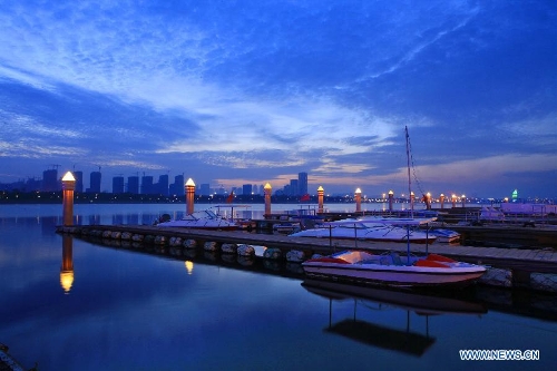 Lights of a water transportation base beacon at sunset in Rizhao, east China's Shandong Province, May 16, 2013. (Xinhua/Li Xiaolong) 