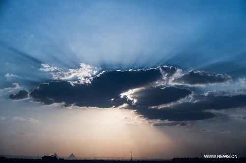 Photo taken on May 15, 2013 shows a sunset view over the famous Giza Pyramids in Cairo, Egypt. (Xinhua/Li Muzi) 