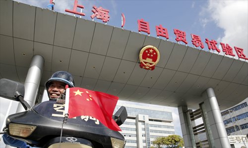 A motorbike rider passes the No. 3 gate of the China (Shanghai) Pilot Free Trade Zone (FTZ) in Shanghai on Friday. Photo: Cai Xianmin/GT 