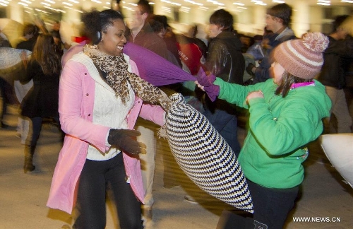People participate in the pillow fight at the Nathan Phillips Square in Toronto, Canada, April 6, 2013. (Xinhua/Zou Zheng) 